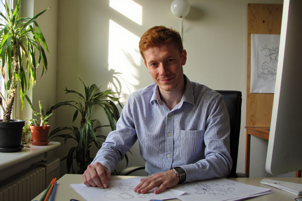 Chris sits at a desk sketching out ideas to bring value to realtors.